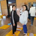 a group of pregnant women standing on mats