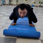 a man doing push ups on a yoga mat